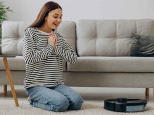 Robot Süpürgenizi İlk Günkü Gibi Kullanın: Temizlik Rehberi 3 robot süpürgesinin başında duran mutlu bir kadın